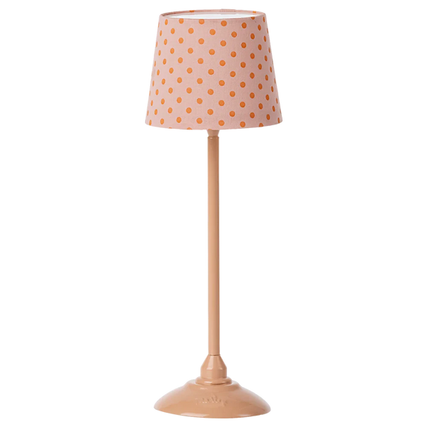 The Maileg Floor Lamp, Miniature in Dark Powder by Maileg features a tall design with a peach-colored base and matching shade, accented by an orange polka dot pattern. It offers a soft tone light and combines metal and cotton elements for a charming touch.