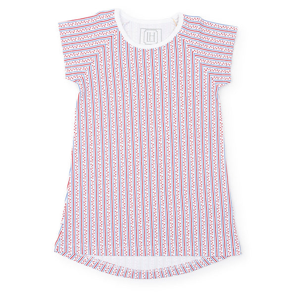 Lila & Hayes Girls' Sadie Dress with short sleeves, white base, and red and blue vertical stripes and patterns, crafted from Peruvian cotton with a slight high-low hem at the bottom.