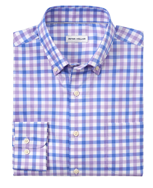 The Peter Millar Castine Crown Lite Cotton-Stretch Sport Shirt is a folded button-up style featuring a blue, lavender, and white checkered pattern. Made from cotton-performance twill, it boasts long sleeves and a front pocket for both style and comfort.