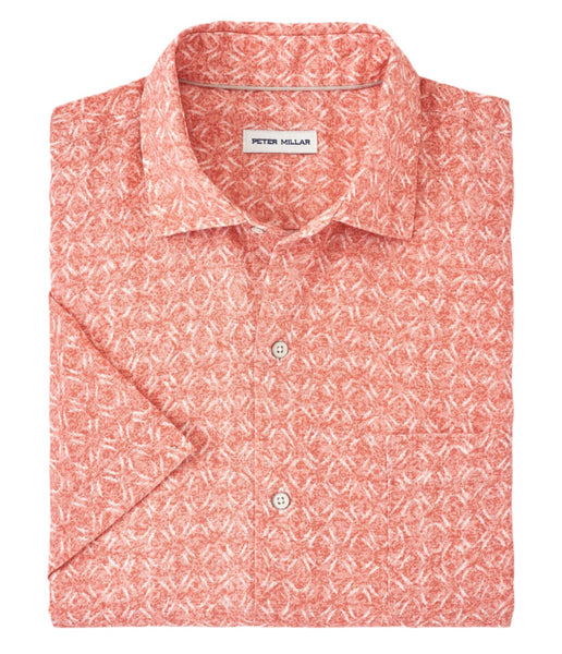 A folded Peter Millar Sandblast Linen Sport Shirt for men, made from 100% linen and showcasing a subtle tropical print on a crisp white background.