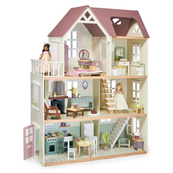 The Tender Leaf Toys' Tender Leaf Mulberry Mansion is a three-story wooden dolls house featuring different rooms such as a kitchen, living room, bedroom, bathroom, and attic. It comes fully furnished and includes two dolls positioned on separate floors.