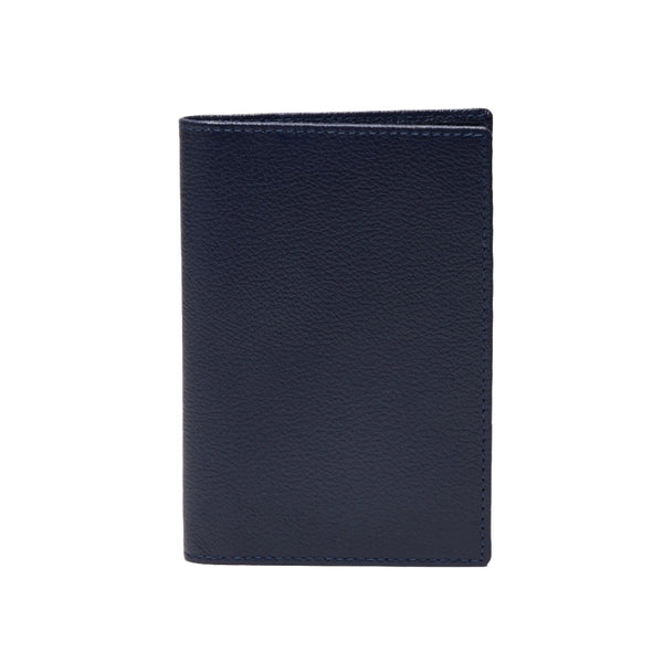 A dark blue Ettinger Capra Passport Case standing upright against a white background.