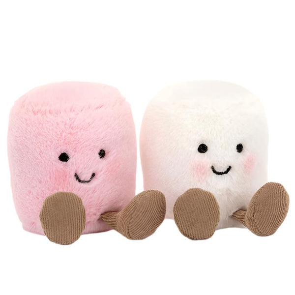 The Jellycat Amuseables Pink and White Marshmallows, both with smiling faces and praline cord boots, sit side by side; one is a cheeky mallow in pink, while the other is in white, each showcasing adorable brown feet.