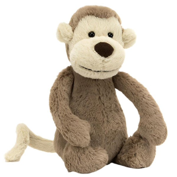 The Jellycat Bashful Monkey, Small, a plush toy with bashful fur in creamy chocolatey brown and cream shades, sits upright against a white background.