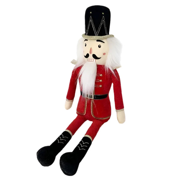 The MON AMI The Nutcracker Shelf Sitter - Red from Mon Ami, featuring white hair, a black hat, and black boots, sits upright against a white background, making it the perfect holiday accent for your home decor.