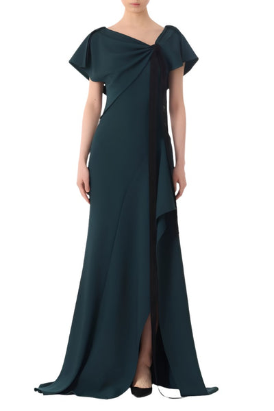 A person is wearing a dark green, floor-length Jason Wu Collection Ruched Fluid Crepe Gown with short sleeves and an asymmetrical neckline.