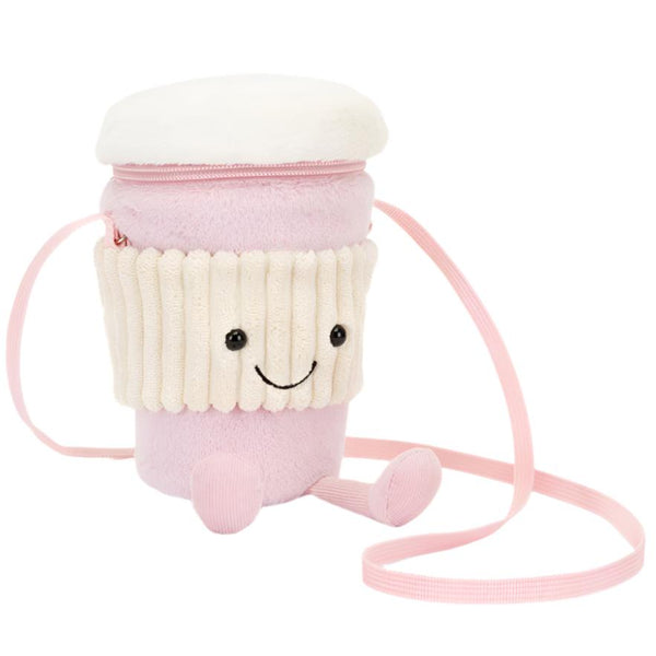 The Jellycat Amuseables Coffee-To-Go Pink Bag is a plush accessory shaped like a pink and white cup, complete with a smiling face, secure zipper closure, and a convenient cross-body strap.