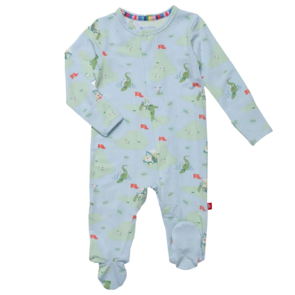 The Magnetic Me A Putt Above Footie by Magnetic Me is a light blue baby onesie with a dragon print and red flags. It features long sleeves, foot covers, and is made from temperature-regulating, eco-friendly TENCEL™ fabric.