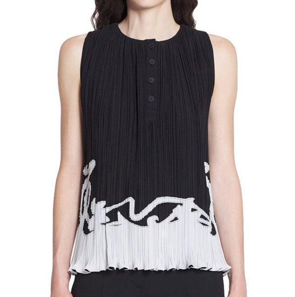 A woman wears a Lanvin Sleeveless Pleated Top with a buttoned front and abstract design near the hem.