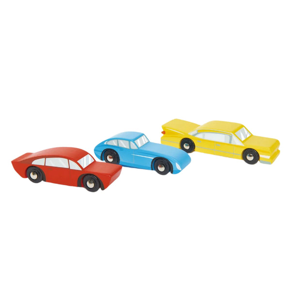 The Tender Leaf Retro Cars from Tender Leaf Toys are arranged in vibrant red, blue, and yellow on a white background, each meticulously crafted to replicate their vintage charm.