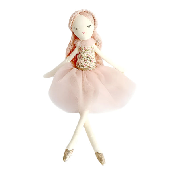 Introducing the MON AMI Rose Scented Doll by Mon Ami, featuring long pink hair and an embroidered face. This charming doll wears a floral top and a pink tulle skirt, complemented by closed eyes and sparkly shoes.