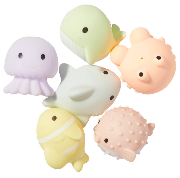 Six colorful marine animal-shaped bath toys, featuring a jellyfish, whale, shark, octopus, fish, and pufferfish, arranged in a circular pattern against a white background. These Sunnylife Sea Animal Splash Toys make for perfect underwater animal buddies during bath time by Sunnylife.