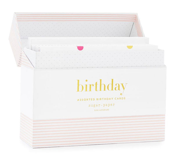 The Sugar Paper Birthday Card Set from Sugar Paper, Los Angeles, is a decorative storage box with dividers labeled "birthday." It features a striped pattern and includes assorted birthday cards along with envelopes adorned with subtle dot designs and colorful details.