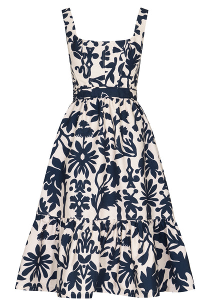 Andres Otalora navy blue and white floral print dress with a fitted bodice, wide straps, and a flared midi skirt in cotton poplin.