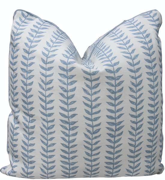 The Willow Pillow by Associated Design is a 22" x 22" handmade masterpiece featuring a pristine white background adorned with a repetitive blue leaf pattern, making it the perfect accent piece for any home decor.