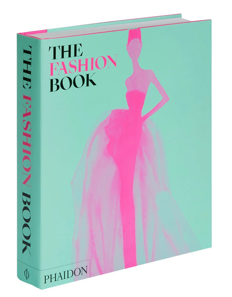 A book titled "The Fashion Book," with a mint green cover and a pink illustration of a woman in a dress, highlights fashion icons and the fashion industry. The spine also reads "The Fashion Book," published by Phaidon.