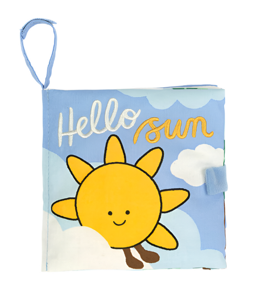 A blue cloth book cover with a smiling sun illustration, white clouds, and the text "Hello Sun" embroidered in white and yellow. This Jellycat Hello Sun Fabric Book features a fabric loop attached at the top left corner, making it easily attachable to buggies or cribs for an interactive story for babies.