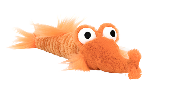 An orange cordy fabric plush toy with large white and black eyes, a textured body, and fluffy appendages, resembling a cartoonish shrimp. Product Name: Jellycat Riley Razor Fish. Brand Name: Jellycat.