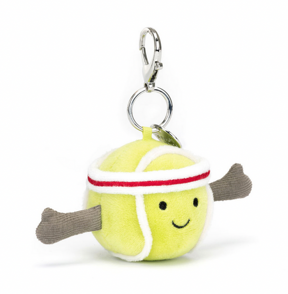 A Jellycat Amuseables Sports Tennis Bag Charm by Jellycat with a smiling face, arms made of grey fabric, and a white and red-striped headband. Perfect as a tennis enthusiast gift or Tennis Bag Charm.