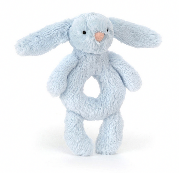 A soft, blue plush toy shaped like a bunny with long ears, black eyes, and a circular hollow in its body. The Jellycat Bashful Blue Bunny Ring Rattle is made from recycled fibers and is suitable from birth.