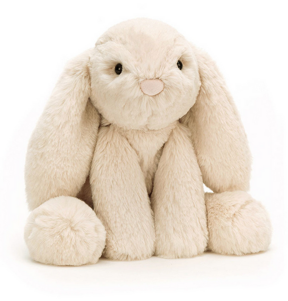 A beige plush bunny with long ears and oatmeal fur sits facing forward, making for a loving companion: the Jellycat Smudge Rabbit, Medium by Jellycat.