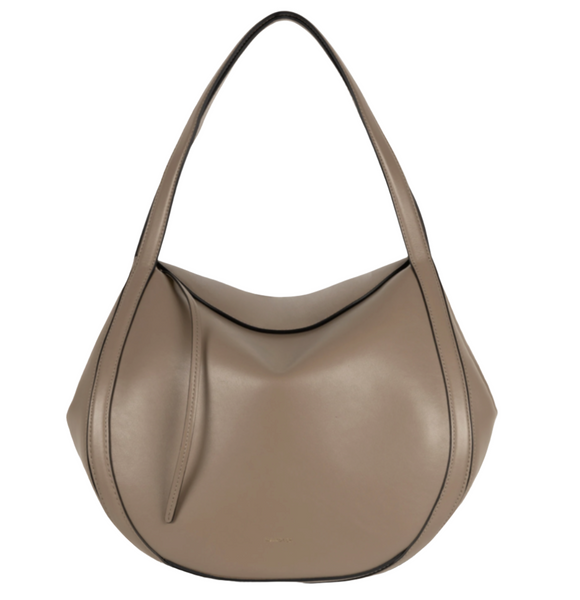 The Wandler Lin Bag by Wandler is a taupe, crescent-shaped handbag crafted from Italian calf leather. It features a single strap and a minimalistic design with subtle seam detailing and golden hardware.