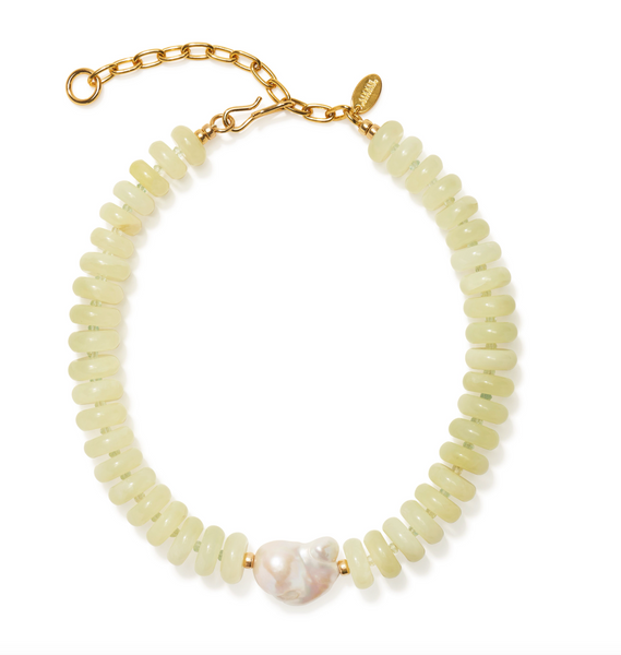 The Lizzie Fortunato Provence Necklace by Lizzie Fortunato features pale green serpentine beads, a single large baroque pearl centerpiece, and a gold chain with clasp.