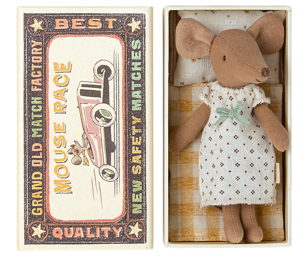 A Maileg Big Sister Mouse in a nightgown is placed inside an open matchbox bed labeled “Mouse Race - Best Quality.” The matchbox, which serves as a cozy toy for kids, features an illustration of a car.