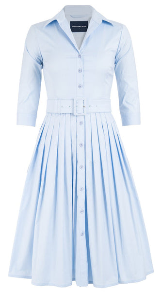 A 1950s-inspired, light blue button-down Samantha Sung Audrey Dress by Samantha Sung with three-quarter sleeves and a belted waist. The cotton stretch fabric ensures comfort and the skirt is beautifully pleated.