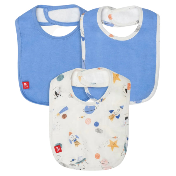 Two of the bibs in Magnetic Me's Stellar Tails Bib 3-Pack are solid blue, and the third features a space-themed design with rockets, stars, and planets. These bibs are equipped with a SewSafe™ magnetic closure for easy wear and made from soft TENCEL™ modal, ensuring both comfort and style for your little one.