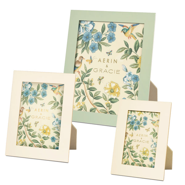 The AERIN x Gracie Heathcote Frame Collection features three photo frames of varying sizes adorned with floral and bird designs, making them ideal for traditional interiors. The largest frame comes in green, while the two smaller ones are white. These frames, inspired by the Heathcote design, are part of the Aerin brand collection.