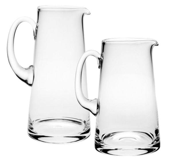 Two classically shaped pitchers with handles from the William Yeoward Crystal Classic Pitcher Collection, ideal for serving lemonade or water.