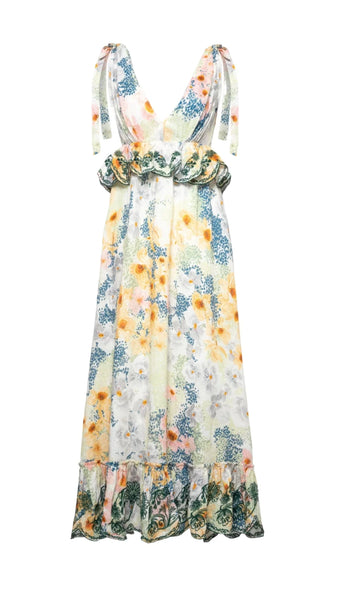 The Agua By Aguabendita Infinito Maxi Dress is a sleeveless floral dress featuring a V-neckline, ruffled waist, adjustable shoulder ties, and a ruffled hem.