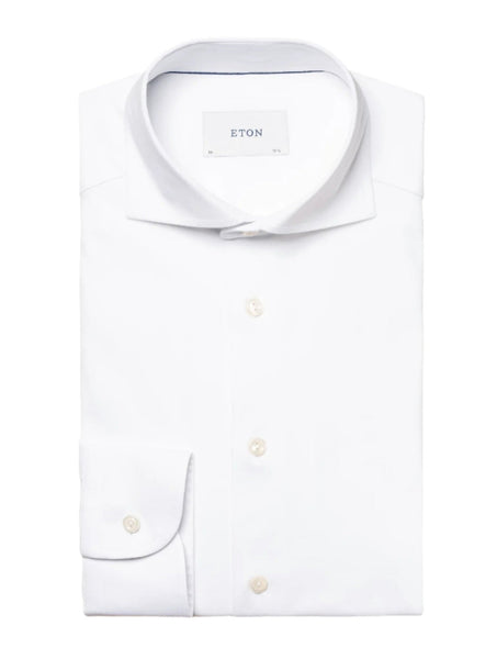 A neatly folded Eton White Four-Flex Shirt, Contemporary Fit with a tag reading "Eton" inside the collar, boasting a refined four-way stretch for ultimate comfort.