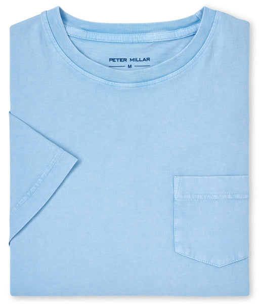 Folded, light blue Peter Millar Lava Wash Pocket Tee with short sleeves and a chest pocket. Crafted from organic cotton, this casual tee is available in size M as indicated on the label.