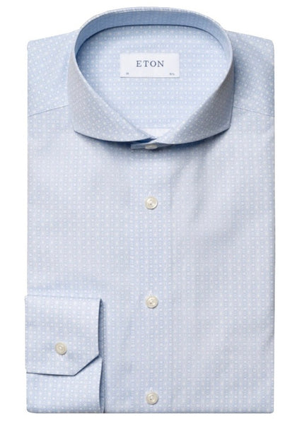 A neatly folded Eton Light Blue Geometric Print Signature Poplin Shirt, Slim Fit, made from 100% cotton, featuring white buttons and a subtle pattern, labeled "Eton" on the inside collar.