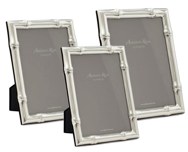 Three frames from the Addison Ross Wide Bamboo Silver Plated Frame Collection, each featuring an elegant bamboo design with "Addison Ross London" displayed on them, are arranged in varying sizes.