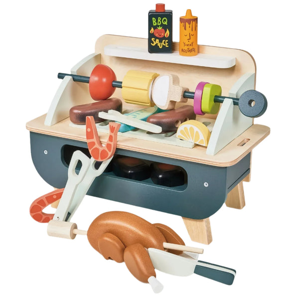 The Tender Leaf Barbeque Play Set by Tender Leaf Toys is ideal for imaginative play, featuring wooden skewers, tongs, sauces, and a removable grill.