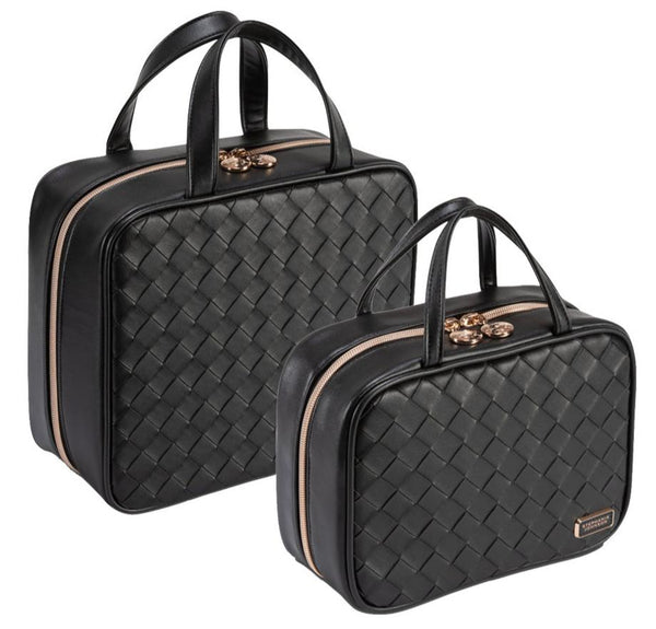 Two black leather travel bags with a woven texture, featuring gold zippers and handles, evoke the essence of a Belize night. The smaller bag, perfect as a cosmetic case with removable compartments, is placed slightly in front of the larger one. These are part of the Stephanie Johnson Belize Raven Travel Collection by Stephanie Johnson.