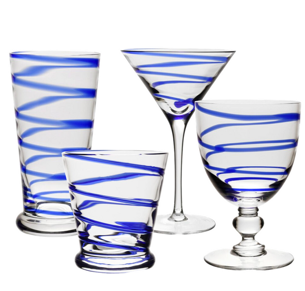 Image of four pieces from the William Yeoward Crystal Bella Blue Collection: a tall tumbler, a martini glass, a short tumbler, and a stemmed goblet with elegant spiral blue designs—perfect for water or wine.