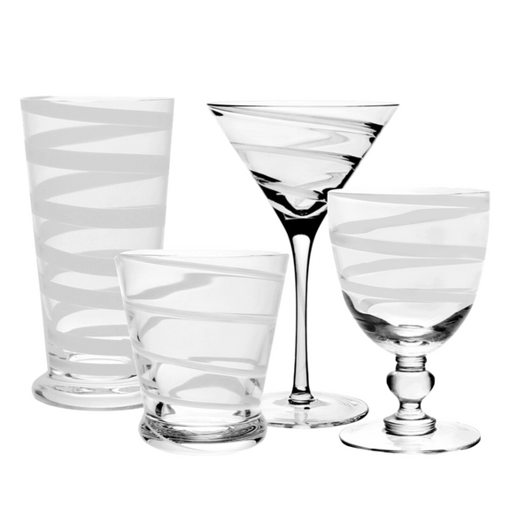 The William Yeoward Crystal Bella Bianca Collection from William Yeoward Crystal features a set of four stylish glasses adorned with elegant white spiral designs. The collection includes a tall tumbler, a short tumbler, a martini glass, and a goblet.