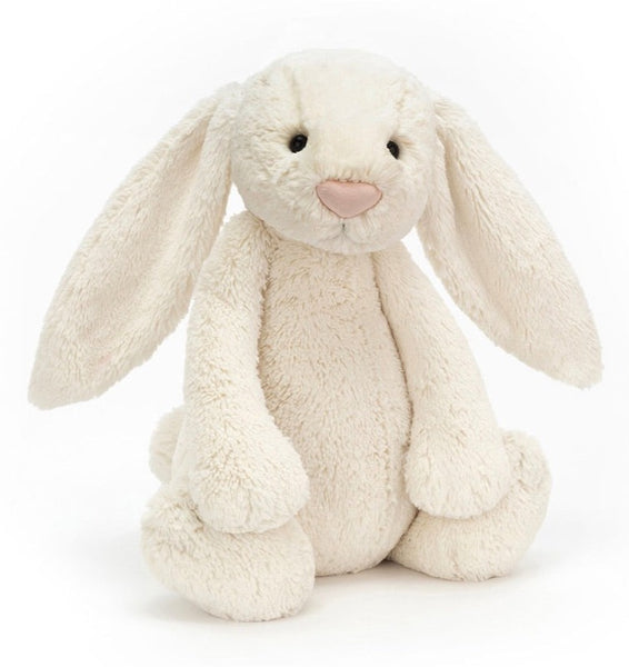 A white plush bunny with long ears, round eyes, and a pink nose sits against a plain white background. This soft bunny toy, known as Jellycat Bashful Bunny Cream, Huge by Jellycat, is the perfect cuddly companion.