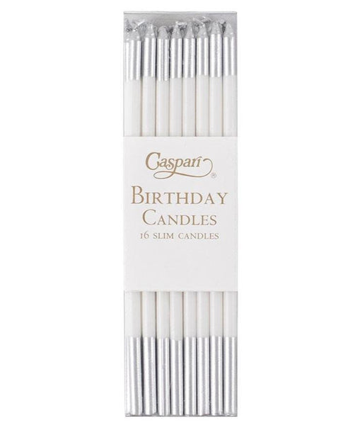 A pack of 16 slim-style birthday candles with silver tips in a transparent plastic box labeled "Caspari Slim Birthday Candles, White/Silver," adding an elegant flair to any celebration.