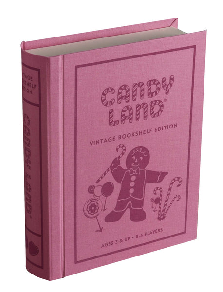 A pink, book-shaped box labeled "Candy Land Vintage Bookshelf Edition" by WS Game Company showcases a charming gingerbread character and delightful candy images. The text states "Ages 3 & Up, 2-4 Players." This collectible edition is an excellent choice for a child's first game.