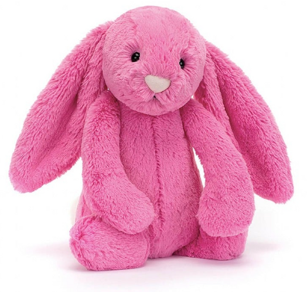 A plush Jellycat Bashful Hot Pink Bunny, Medium with dragon fruit fur, long ears, black eyes, and a white nose sitting upright against a plain background.