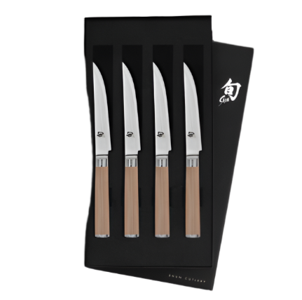 The Shun Classic Blonde Steak Knife Set, 4-Piece, showcases a VG-MAX Cutting Core with razor-sharp edges and elegant wooden handles, all nestled in a sleek black box.