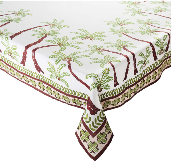 Introducing the Kim Seybert Oasis Tablecloth by Kim Seybert, featuring a white backdrop adorned with green and brown swaying palm patterns and a geometric border design, all crafted from 100% linen to capture an island vibe.