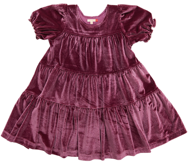 A stunning Pink Chicken Girls' Velour Elizabeth Dress, featuring a sugarplum-colored velvet fabric with short puffed sleeves and a tiered skirt, is displayed against a white background. It's the perfect holiday dress.