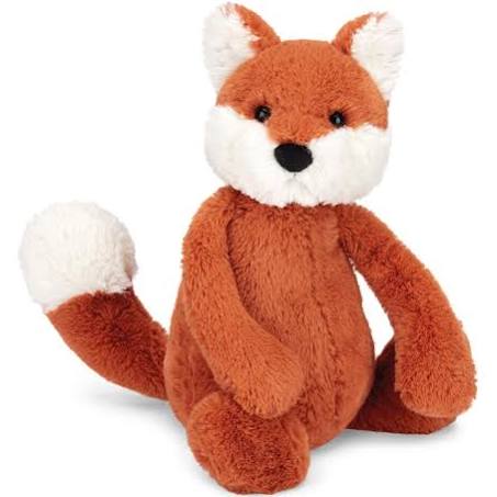 A red and white stuffed animal fox, affectionately known as Jellycat Bashful Fox Cub, Medium, with a black nose and long tail sits upright against a plain white background. Crafted from soft polyester fibers, this ginger cub exudes charm and coziness from the Jellycat brand.