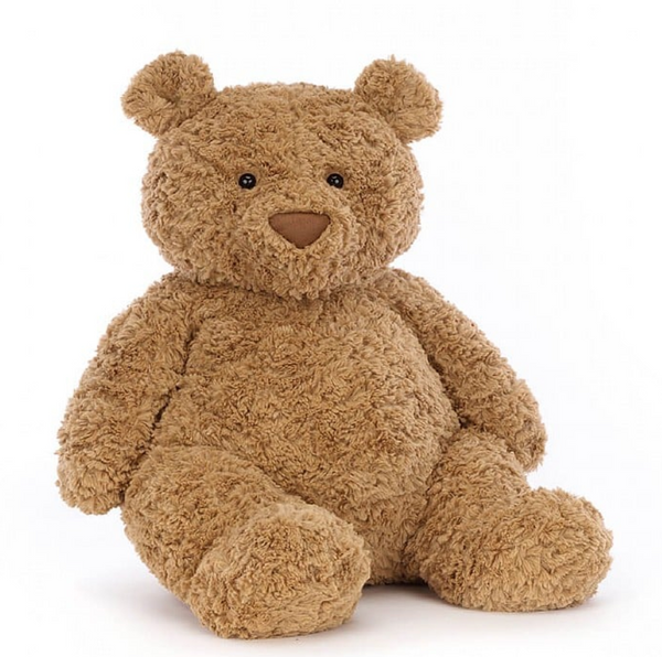 A soft, brown teddy bear with a fuzzy texture, round ears, and a small smile sits upright against a plain white background. This is your lovable Jellycat Bartholomew Bear, Really Big, the perfect bedtime buddy with his fluffy fudge tummy ready for endless cuddles.